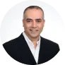 A man in a black suit and white shirt.